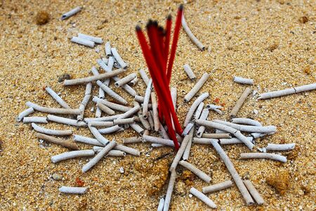 The ashes of incense that remain in the shape of sticks in the incense burnerの写真素材