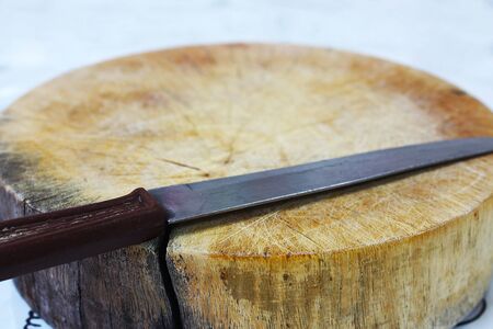 A small knife placed on a chopping board