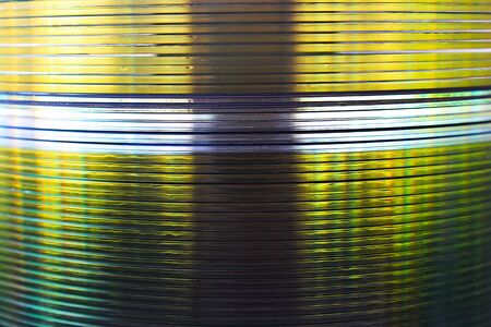 The CDs are stacked in many layers as a background