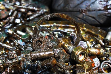 A pile of old rusty bolts that mess up engine oil at the old car spare parts market, Bangkok,...