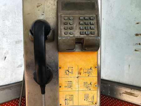 Old and broken public phone in Thailand