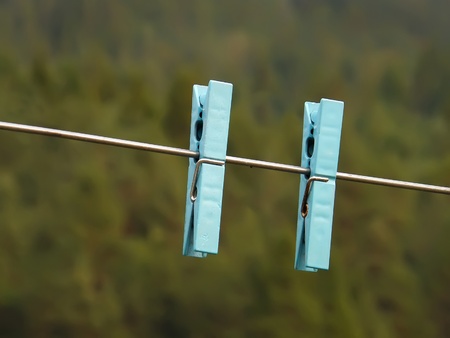 two clothes pegs closeup outdoorsの写真素材