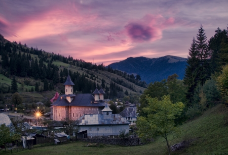 rural Romanian church in sunset landscape