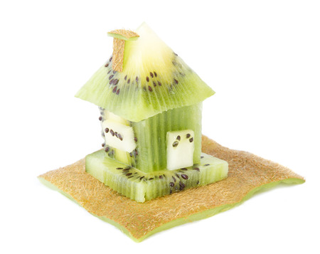 House made of fresh kiwi fruit isolated on whiteの写真素材