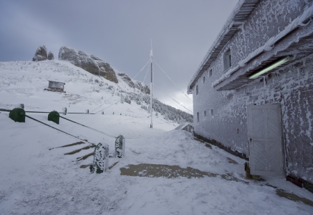 winter landscape and Ceahlau weather station, Romaniaの写真素材