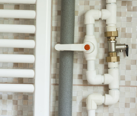 closeup of water pipes inside bathroom