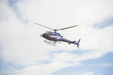 blue helicopter in the skyの写真素材