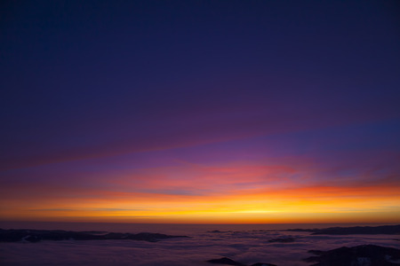 beautiful sunset or sunrise with color sky on the mountainの写真素材
