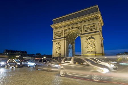 traffic of cars at Arc de Triomphe in Paris city, France. night sceneの写真素材