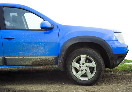 dirty blue car full of mudの写真素材