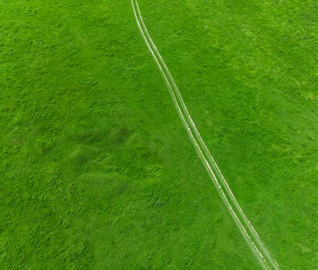 aerial view of countryside road in the green summer meadowの写真素材