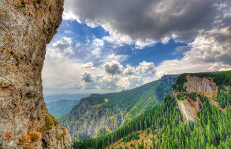 summer mountain landscape in Romania, rock and sky with cloudsの写真素材