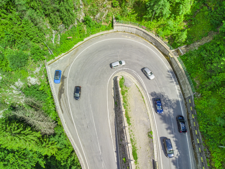 curved road with cars and beautiful forest landscape. Bicaz gorges, Romania. Aerial view from drone