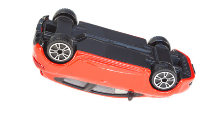 red toy car flipped. accident concept for insuranceの写真素材