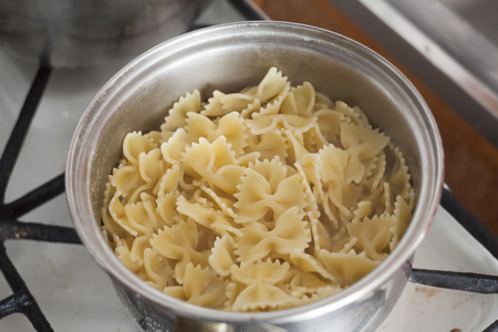 pot with pasta on the fire stove cookingの写真素材