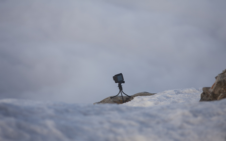 action camera for photo and video on a tripod in mountain landscapeの写真素材