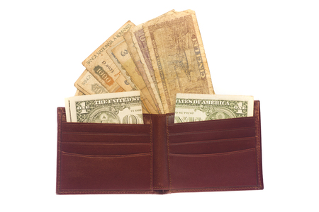 vintage leather wallet full of old money isolatedの写真素材