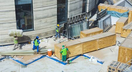 workers at construction site outdoors, pavementの写真素材