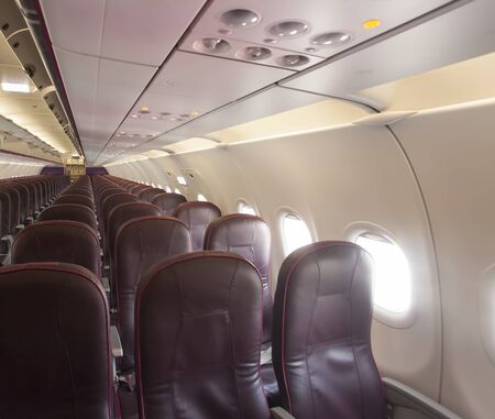 interior of airplane with chair and white window