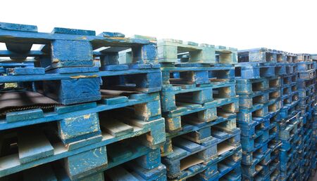 blue wooden pallets for cargo transport isolated on whiteの写真素材