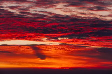 sunset sky with red cloudsの写真素材