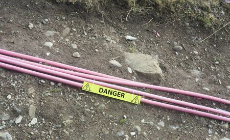 wire cables for electricity out on the ground. danger concept