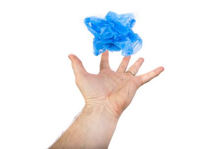 hand holding blue plastic bag isolated on white background. recycle or polution conceptの写真素材