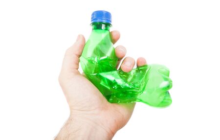 hand holding green plastic bottle for soda drink isolated