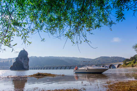small fishing boat or yacht on the Bicaz lake. Romania landscape