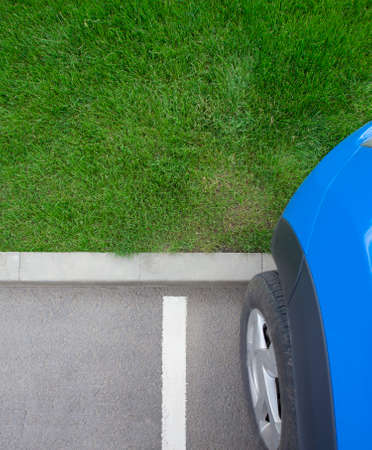 car in the parking lot with green grass background for your textの写真素材
