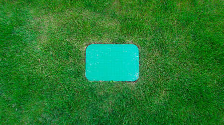 green grass meadow and board in the centerの写真素材