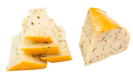 slices of gouda cheese with herbs. sliced and isolated on white backgroundの写真素材