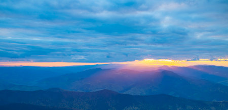 sunset landscape with clouds and mountainsの写真素材