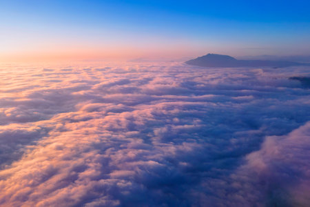 sunset above the clouds, aerial image of Ceahlau mountain. Romaniaの写真素材