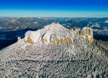 Ceahlau Toaca mountain top in Romanian Carpathians. aerial scene in winterの写真素材