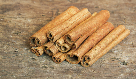 Dried cinnamon placed on the old woodの写真素材