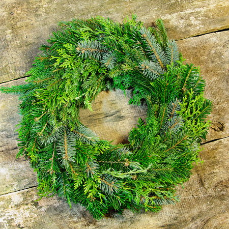 Christmas fresh wreath placed on wooden deskの写真素材