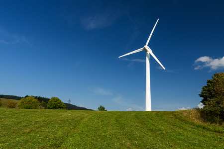 Wind power plant, blue sky with clouds, green grassの写真素材