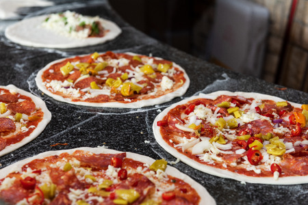 Close up of preparing pizzas in traditional italian restaurantの写真素材