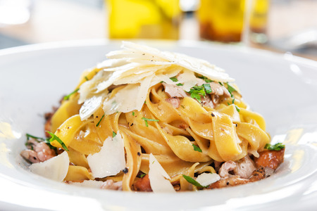 Tasty pasta with cream, cheese and parsley close upの写真素材