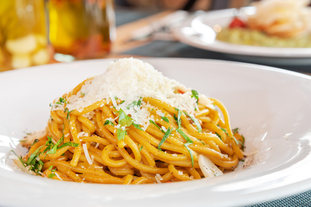 Tasty pasta with cream, cheese and parsley close upの写真素材