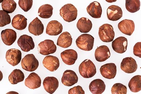 Hazelnut unpeeled isolated white background. Pile of hazelnut closeup. Nuts collection.