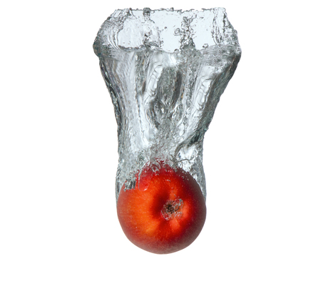 Fresh fruits, apple falling in water splash, isolated on whiteの写真素材