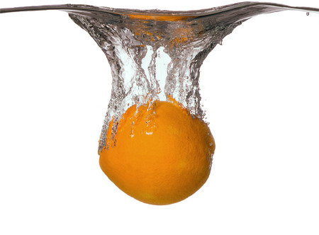Fresh fruits, orange falling in water splash, isolated on whiteの写真素材