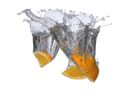 Fresh fruits, orange falling in water splash, isolated on whiteの写真素材