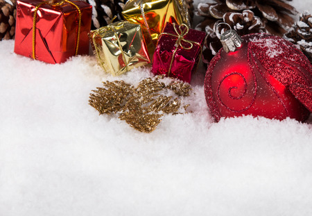 Christmas border with ornament, golden, red present and snowの写真素材