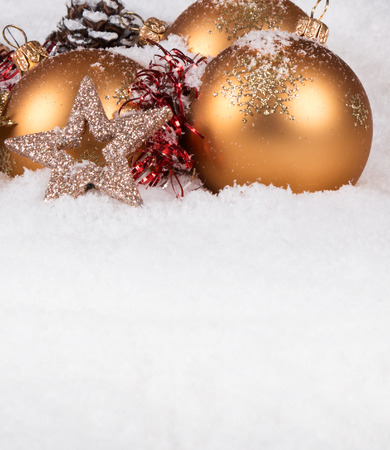 Christmas border with ornament, golden, red present and snowの写真素材