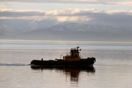 industrial ship with mountains in the background.の写真素材