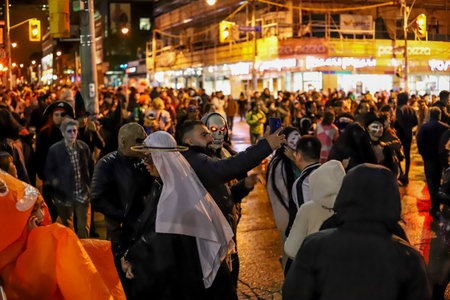 Halloween night carnival . Church street, people walking in different masks and costumes. Toronto, Ontario/Canadaのeditorial素材