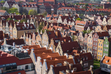 Gdansk, Poland. Historical brick colorful building, red roofs and Baltic sea canal. Sunny day, spring time. Aerial view.の写真素材